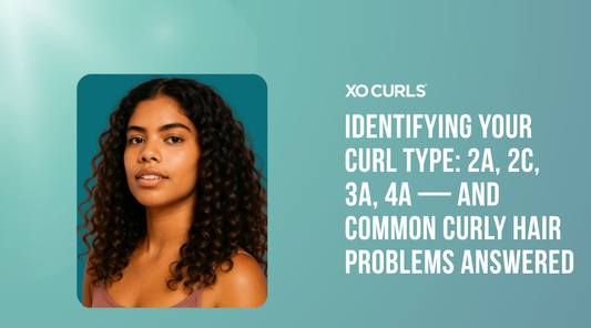 Woman with defined, voluminous curly hair in a mauve top against a deep teal background, featured in XO Curls’ blog titled “Identifying Your Curl Type: 2A, 2C, 3A, 4A — and Common Curly Hair Problems Answered.”